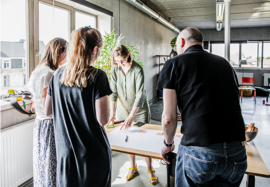 A group of people looking at documents on a table